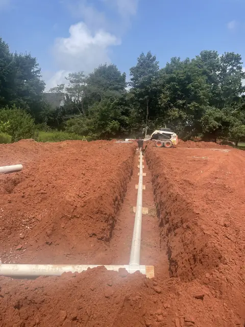 Distribution pipe laid in a straight red-soil trench